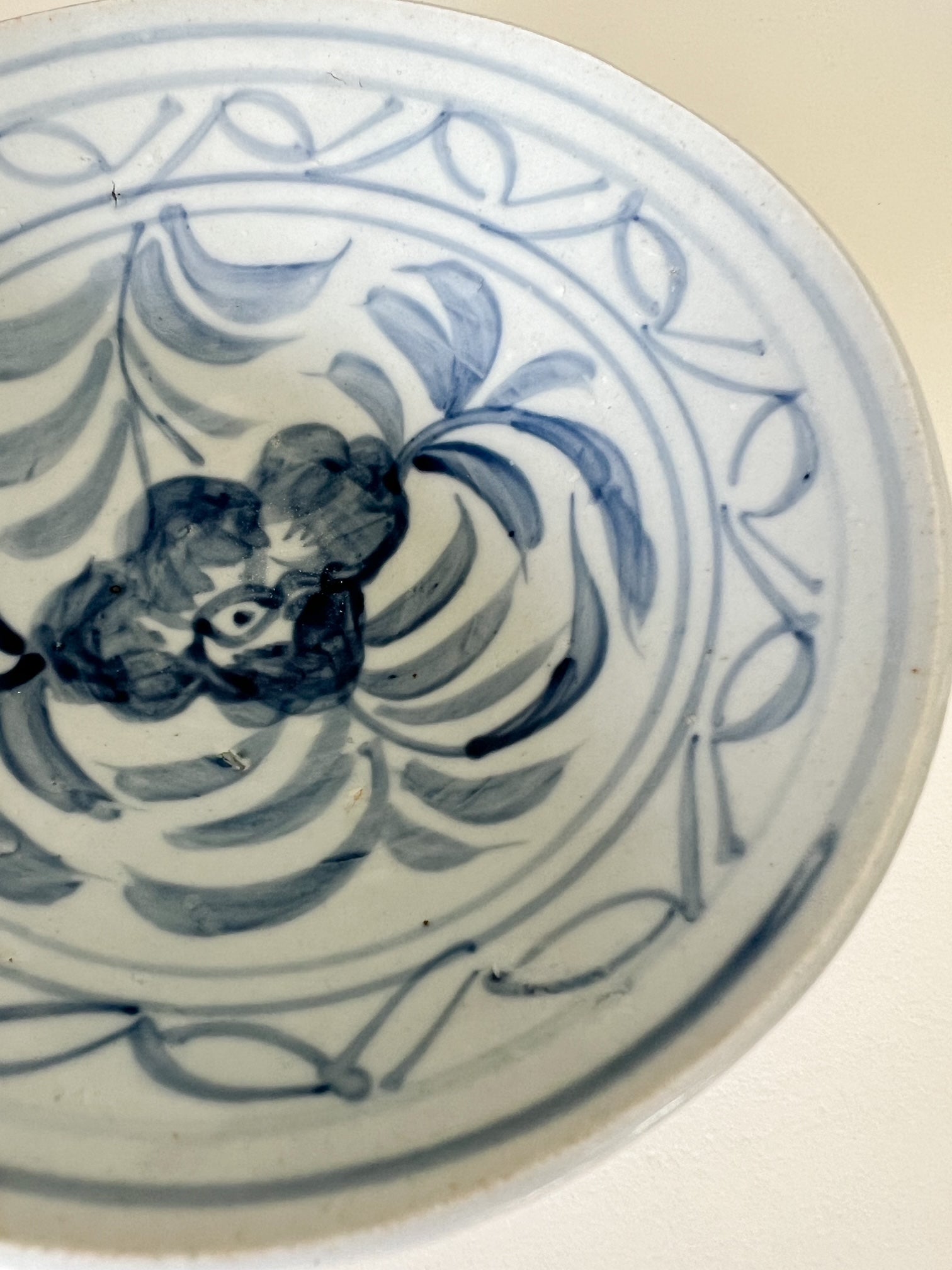 Close-up top view of a floral painted blue bowl