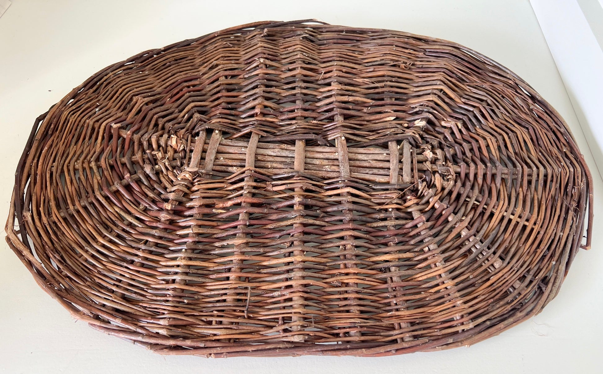 3/4 top view of Handwoven oval placemat in brown tones