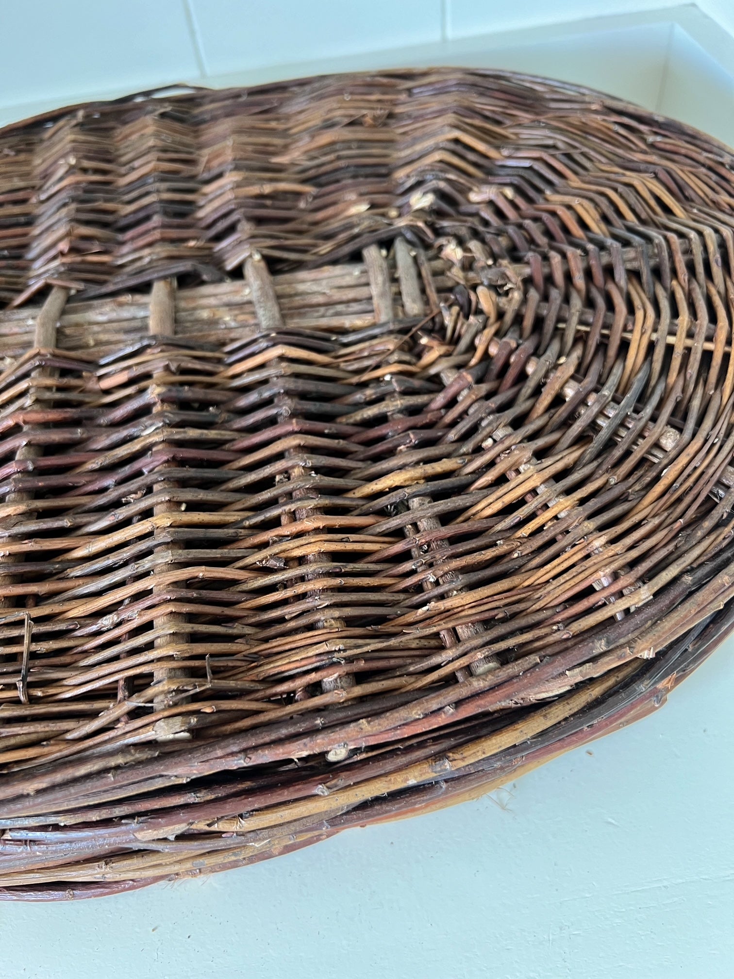 Close-up of round, natural placemats handwoven from willow